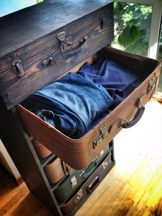 an old suitcase is open and sitting on the floor