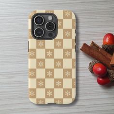 an iphone case sitting on top of a wooden table next to fruit and cinnamon sticks