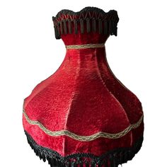 a red and black lamp shade with tassels