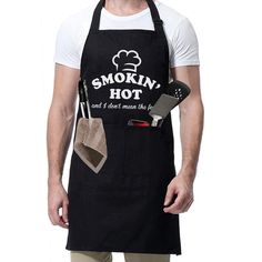 a man wearing an apron and cooking utensils in front of his face with the words smokiin'hot on it