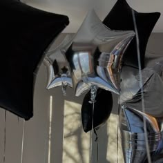 black and silver balloons are hanging from the ceiling