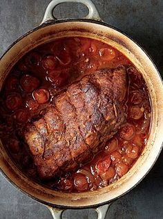 a pot filled with meat and vegetables on top of a table