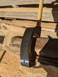 a close up of a hammer on a piece of wood