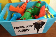 a blue bin filled with toys on top of a wooden table