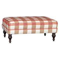 the foot stool is upholstered with an orange and white checkered fabric