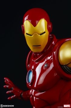 the iron man action figure is posed in front of a black background