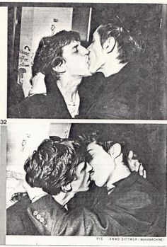 two people kissing each other in black and white