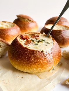 some bread rolls with cheese and spinach spread on them, ready to be eaten