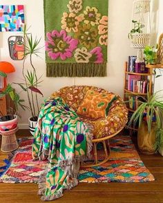 a living room filled with lots of colorful furniture and rugs on top of a wooden floor