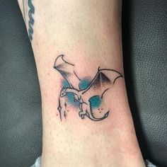 a tattoo on the foot of a person with a bat in it's hand