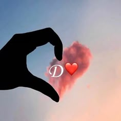 a person's hand making a heart shape with the word p in front of them