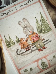 a christmas card with an image of a rabbit on a sleigh