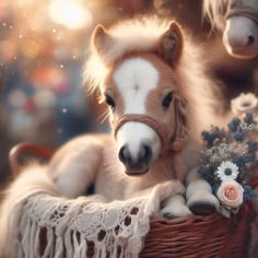 two miniature horses sitting in a basket with flowers on the table next to each other