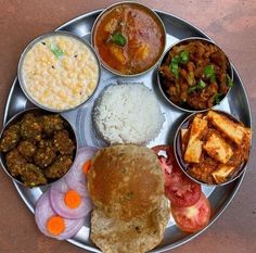 a metal plate topped with different types of food