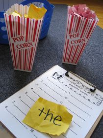 two popcorn bags with the word the on them are next to a piece of paper