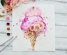 an ice cream cone with pink flowers on it and some crayons next to it