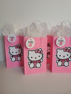 three pink bags with hello kitty on them