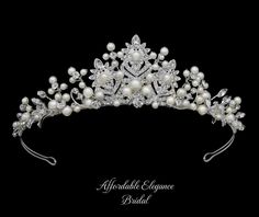 Pearl and Rhinestone Wedding Tiara This beautiful bridal tiara features a silver plated design encrusted with glistening rhinestones as well as hand-wired sprigs of rhinestones and pearls. This 1 1/2" tall headpiece is the perfect understated size and will add a romantic touch to your wedding ensemble! Size: About 1 1/2" tall at its center peak. Color: Silver / Light Ivory. Style: hp3173. Please allow 1 week for delivery. Shipping Policy . Return Policy Beaded Edge Veil, Veil Pearl, Winter Wedding Accessories, Gold Bridesmaid Jewelry, Beaded Wedding Veils, Rose Gold Tiara, Rose Gold Bridesmaid, Tiara Headpieces, Veil Accessories