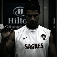 a man standing in front of a locker room holding his hands up to the side