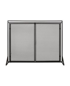 a black metal fireplace screen with two doors