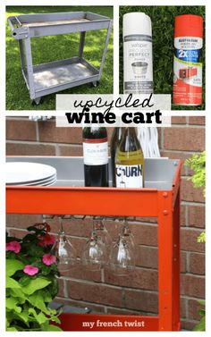 an orange cart with wine glasses and bottles on it, sitting in front of a brick wall