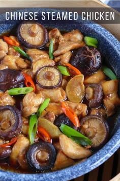 chinese steamed chicken in a blue bowl with carrots and onions