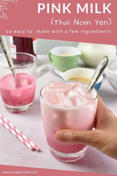 a person holding a pink drink in their hand with the words pink milk on it