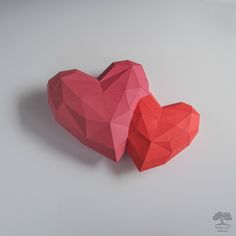 two red paper hearts sitting on top of each other