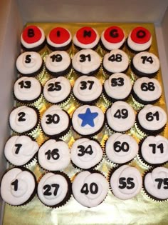 cupcakes with numbers and stars are arranged in a box on top of each other