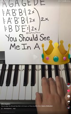 someone is playing the piano with a crown on it