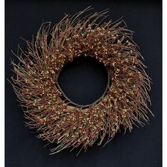 a wreath with gold and red tinsel on it