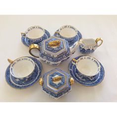 a blue and white tea set with gold accents