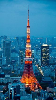 the eiffel tower is lit up in red and white at night with city lights behind it