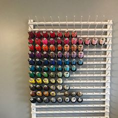 the wall is filled with many different colored spools