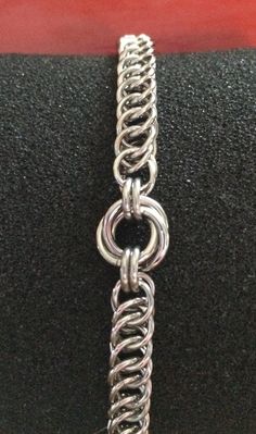 This is a handcrafted Chainmaile bracelet made from stainless steel cut jump rings featuring a Mobius knot in the center with the half Persian 4-1 wave chain finished with a beautiful and simple stainless steel lobster clasp. The knot is approximately 12 mm in size and the chain is 7 mm wide by 4 mm thick. Please convo with me for the size that you need I really like using stainless steel rings because they're strong and they don't tarnish or fade. Jump Ring Necklace, Chain Mail Bracelet, Chainmail Patterns Tutorials, Chainmail Weaves, Jump Ring Bracelet, Chainmaille Patterns, Chainmaille Ring, Chainmaille Jewelry Patterns, Chain Maille Patterns