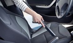 a woman cleaning the interior of a car