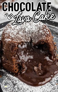 a chocolate lava cake on a plate with powdered sugar and chocolate sauce in the middle