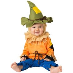 a baby sitting on the ground wearing a costume