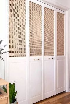 an empty room with white walls and wooden flooring is decorated with woven screens for privacy