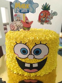 a spongebob cake with yellow icing and decorations on it's face