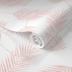 a pink and white wallpaper with palm leaves on the side, as well as a roll of tape