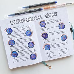 an open astrological sign book on a table with markers and pencils next to it