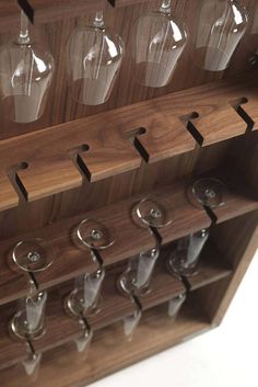 several wine glasses are lined up on a shelf