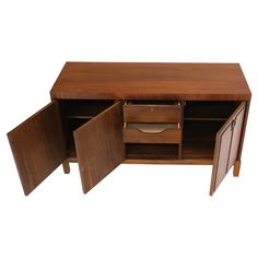 a wooden desk with two doors open on the top and one drawer closed at the bottom