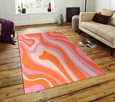 an orange and pink rug in a living room