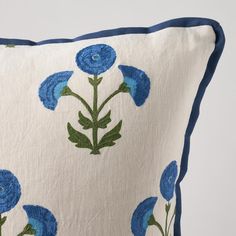 a blue and white pillow with flowers on it