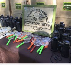 there are many glasses and cups on the table at this outdoor event that is set up