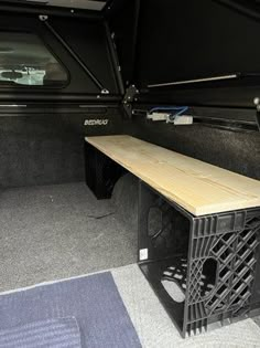 the back end of a truck with a table in it