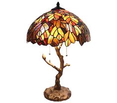 a lamp that is on top of a wooden base with a tree in the middle