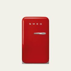 a red refrigerator with the word smeg on it's front and bottom door